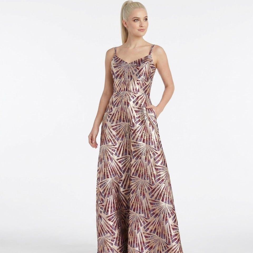 Woman wearing a patterned one-shoulder gown on a white background